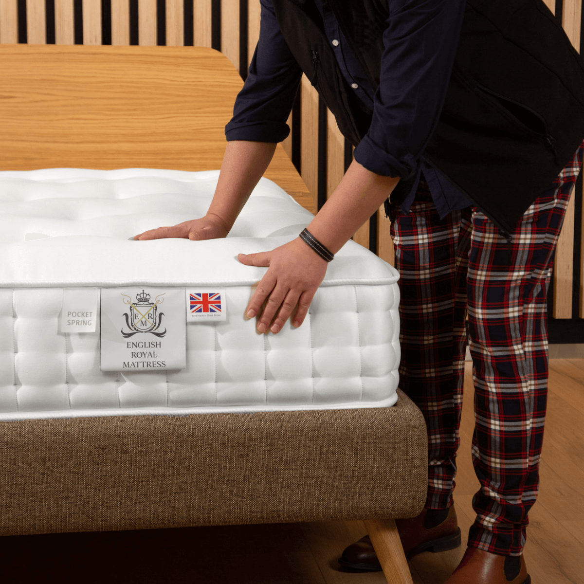 Person adjusting English Royal Mattress, showcasing natural, organic, hand-made traditional mattress with pocket spring technology.